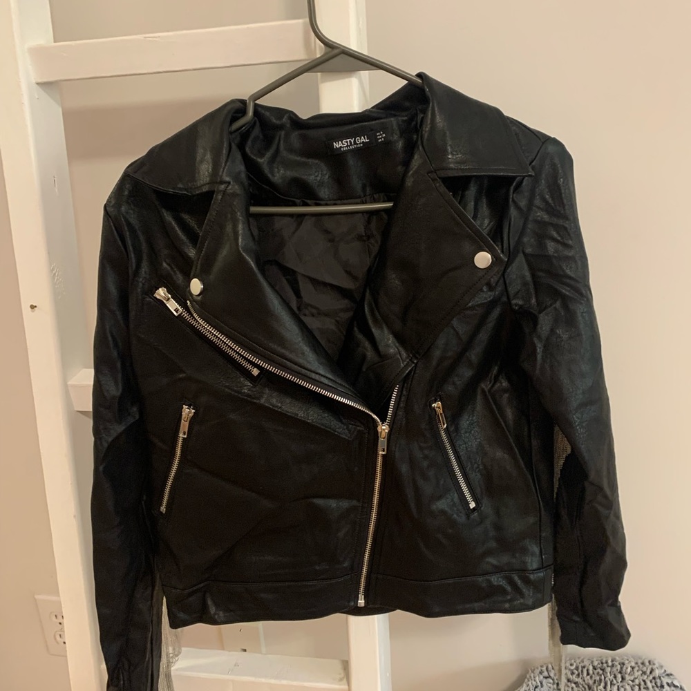 Black leather. Silver zippers and fringe. Size 4 women’s. Excellent condition.